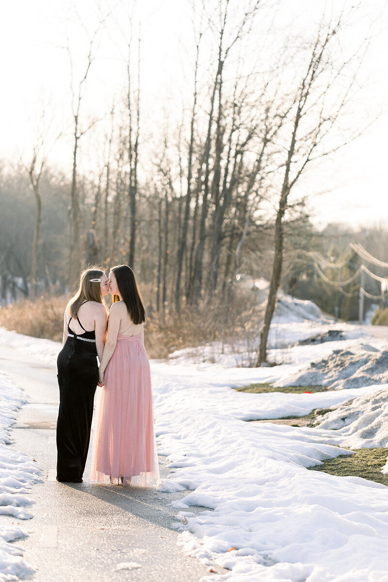 two brides touching noses in their formal gowns