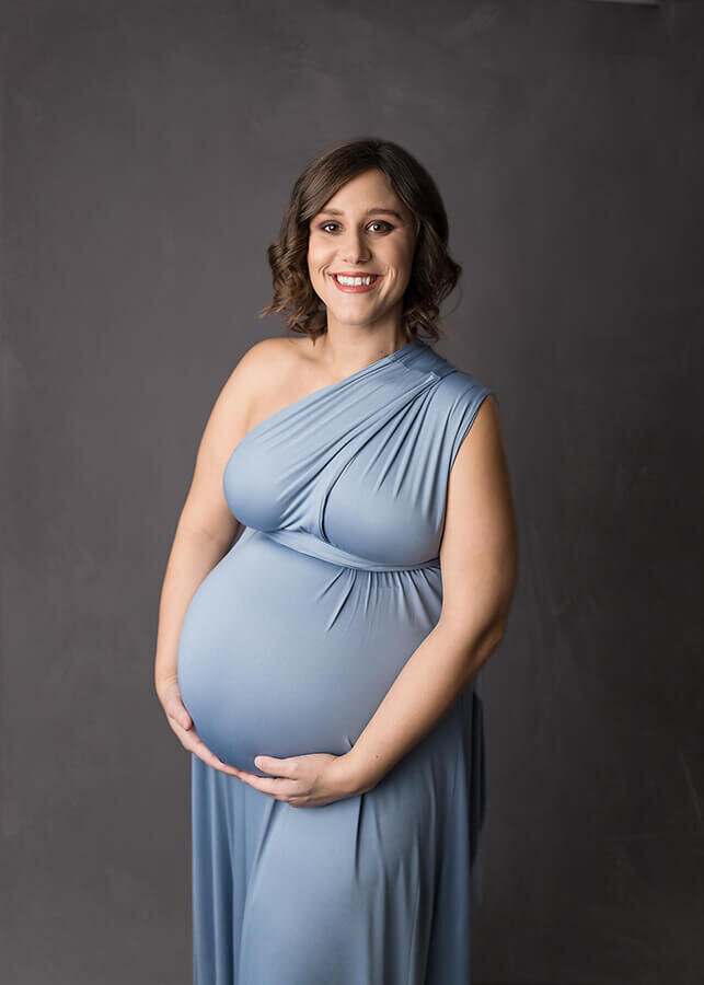 Maternity photo with mother holding baby bump