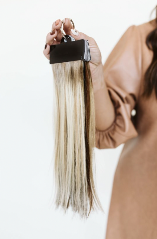 Close-up of a stylist holding a hair extension sample