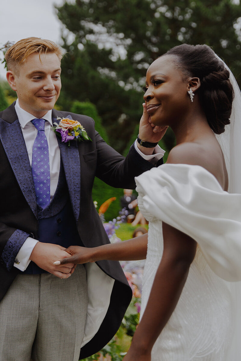 English groom and Ugandan bride at their at home marquee wedding.