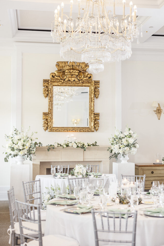 an elegantly decorated white and gold wedding reception