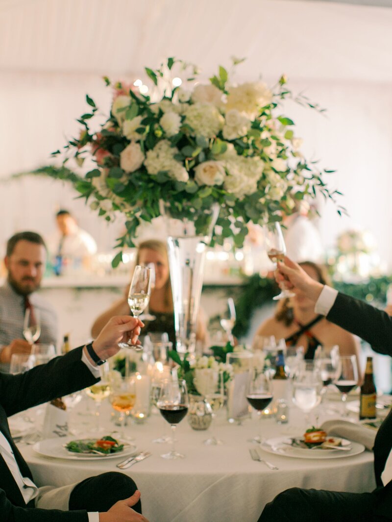 Guests clink glasses during wedding toast