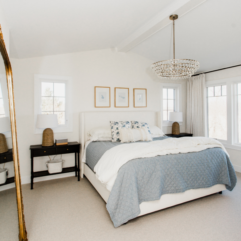 Warm white bedroom with blue bedding and white walls