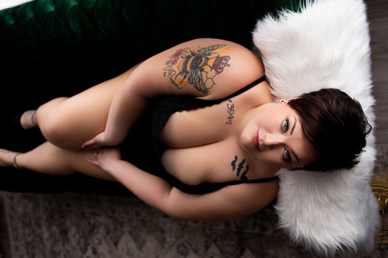 Woman in black leaning against bed taken by new jersey boudoir photographer