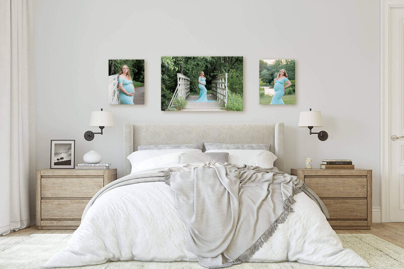 A bedroom displaying canvases of a mom-to-be in a blue dress.