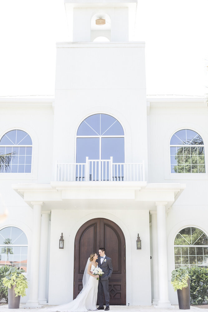 bride and groom standing in front of Harborside Chapel
