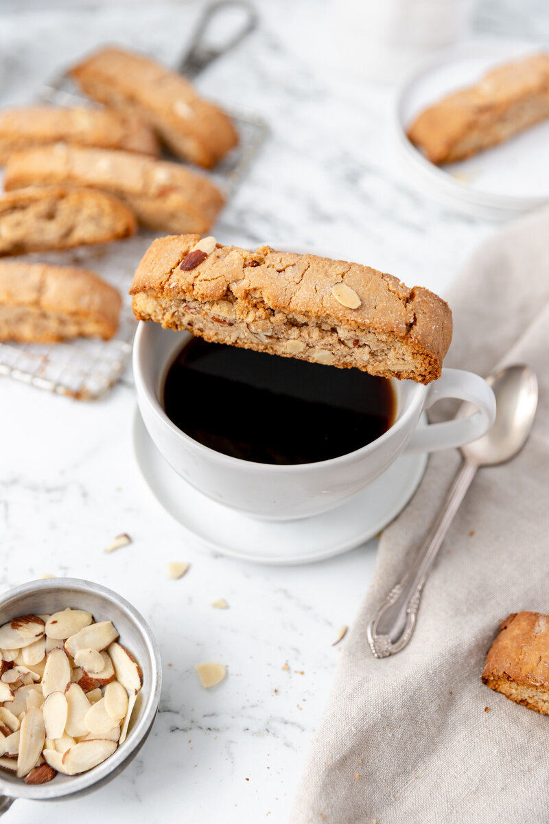 a biscotti cookie sitting on top of a cup of coffee