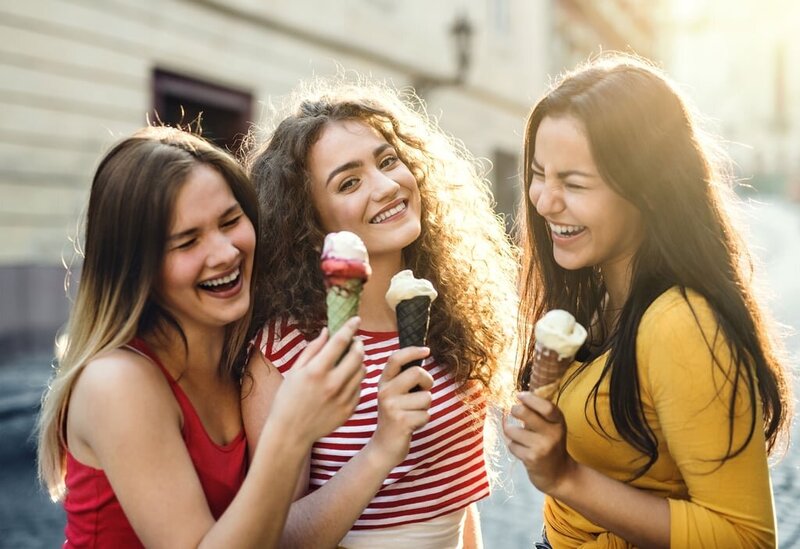 Happy women eating ice cream