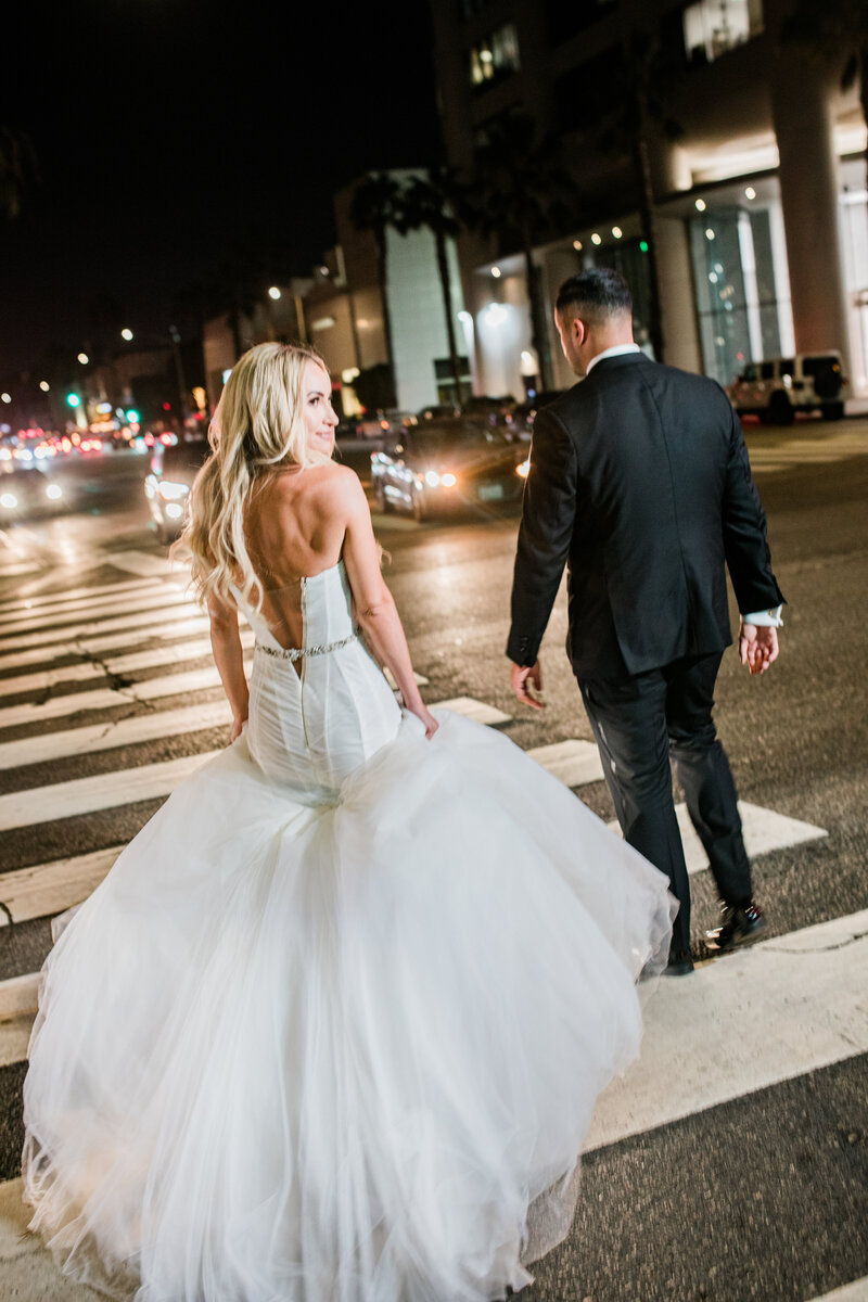 Newlywed couple crossing the street at night, by Connecticut wedding photographer Simply K Studios.