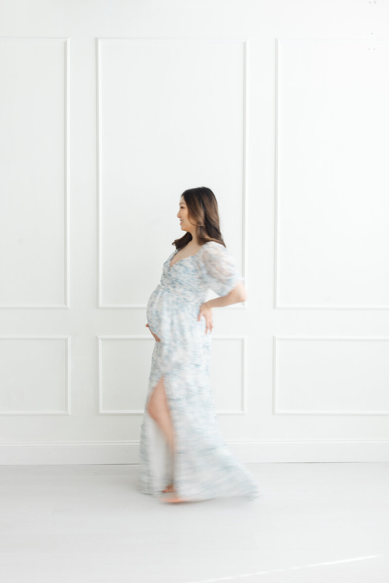 Beautiful pregnant woman poses for portrait during maternity photography session