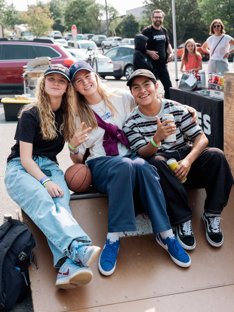 Three girl skaters smiling in group photo