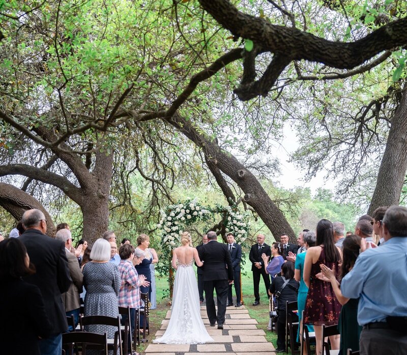 Austin Texas Photographer captures bride walking down the aisle at Vineyards at Chappel Lodge