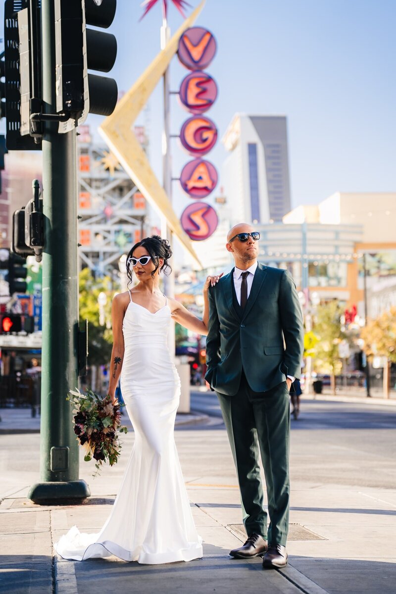 Couple in Fremont street in Las Vegas during their elopement.