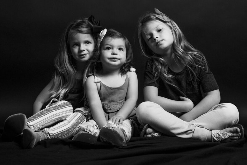Luxury Family Portraits by Moving Mountains Photography in NC - Black and white photo of  three little girls looking at the camera.