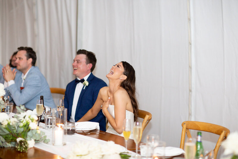 Bride and Groom laughing during the speech