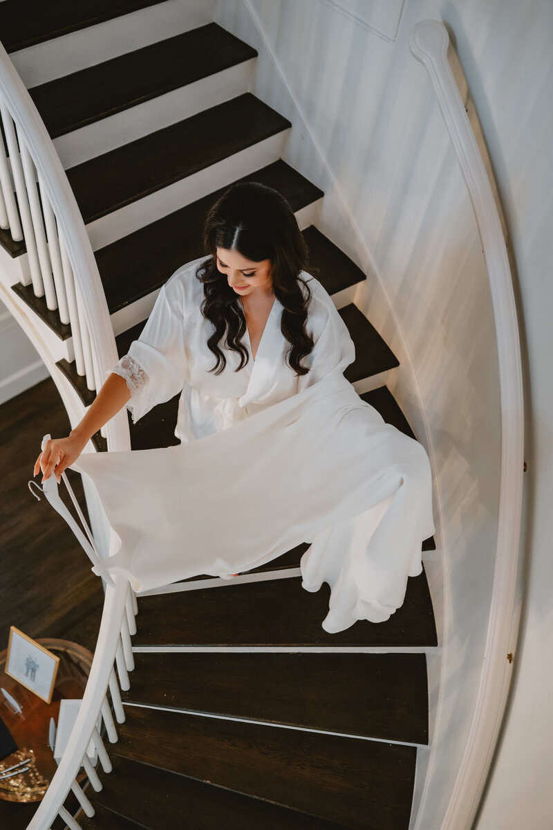 A bride walking down the staircase elegantly