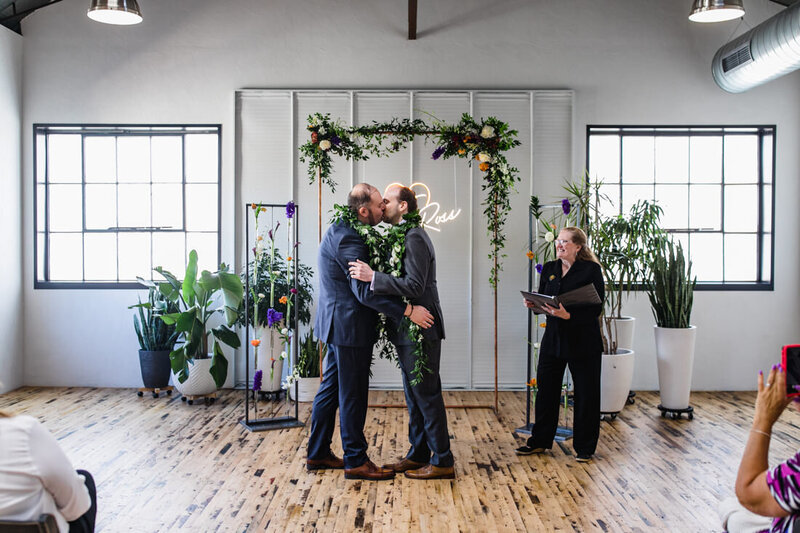 Same sex couple kiss on their wedding day