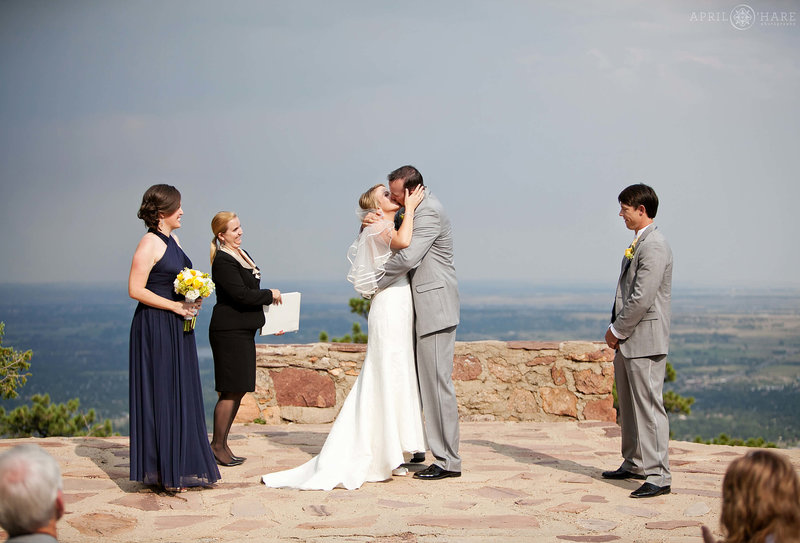 First Kiss wedding ceremony with views of Boulder at Sunrise Amphitheater