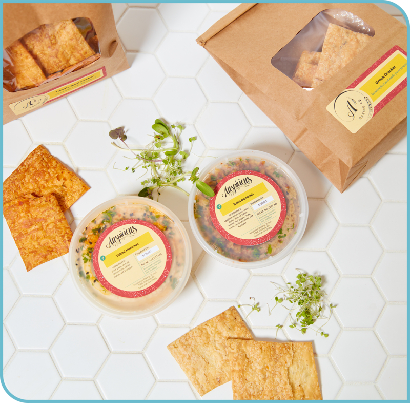 Bags of crackers and containers of dips with custom labels
