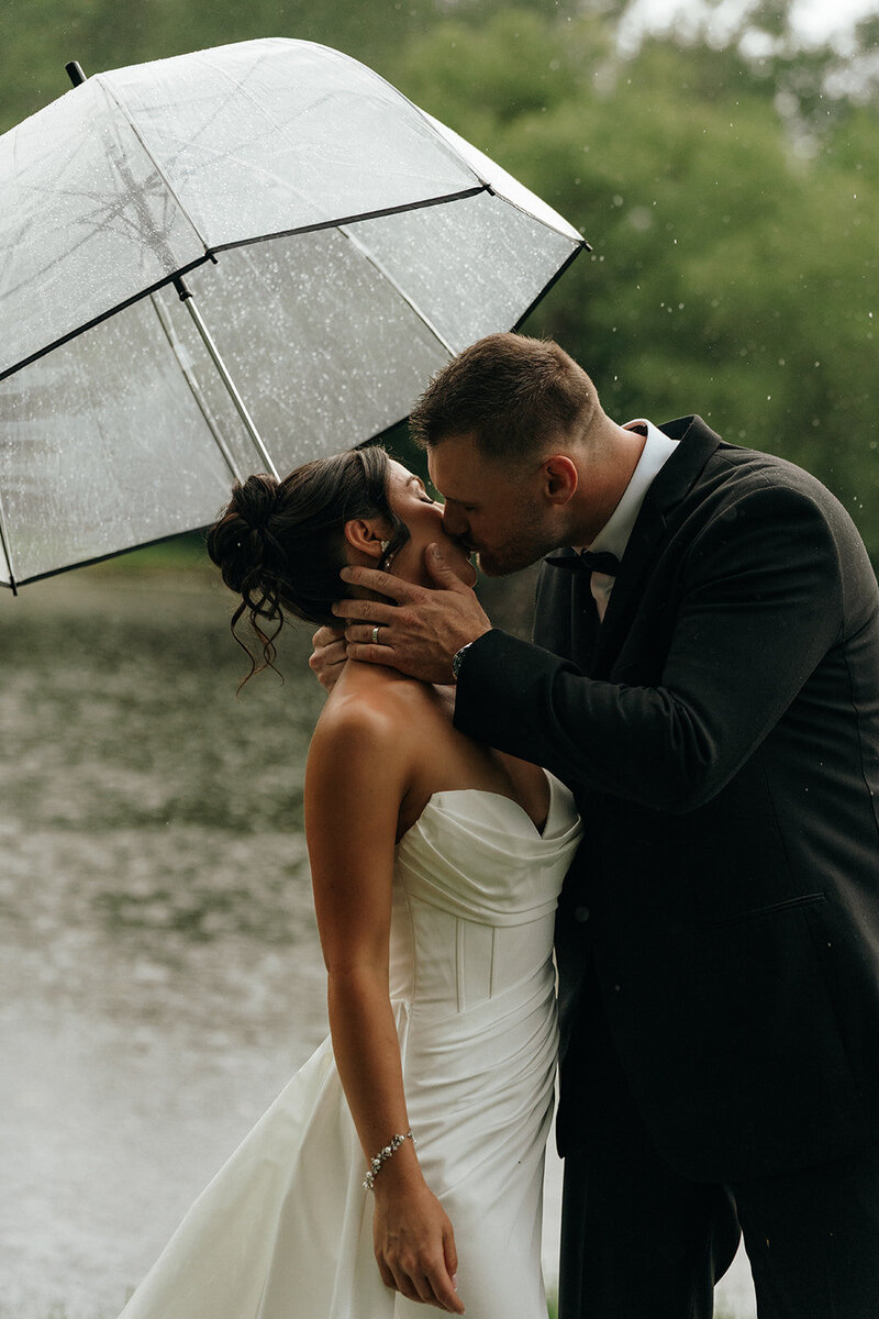 Rhode Island and Destination Wedding Photographer | Cinematic, Moody, Storytelling | Aisha Lee Photography | Bride and groom kissing under the rain