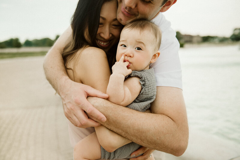 Beautiful asian family hugging with baby