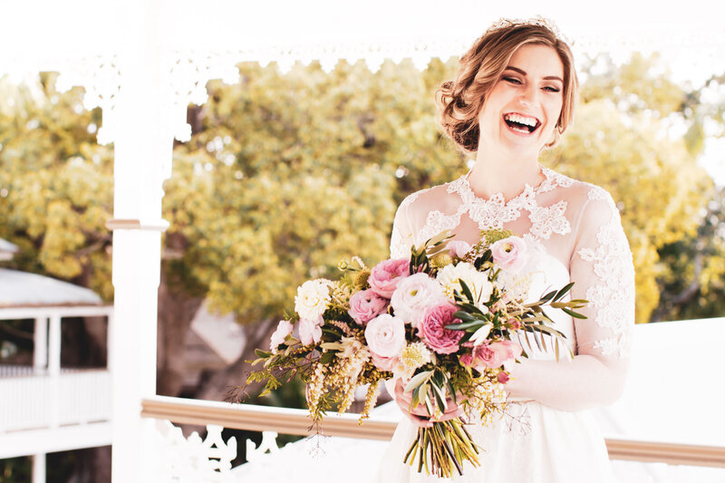 Happy bride smiling with a bouquet in her hands