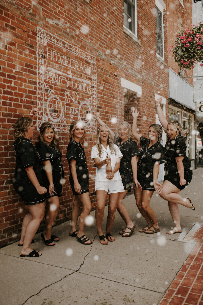Bridal Party popping Champagne