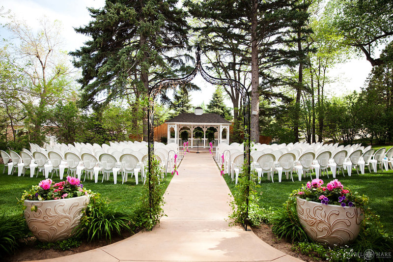 Outdoor ceremony space on the front lawn at Tapesty House during June in  Fort Collins Colorado