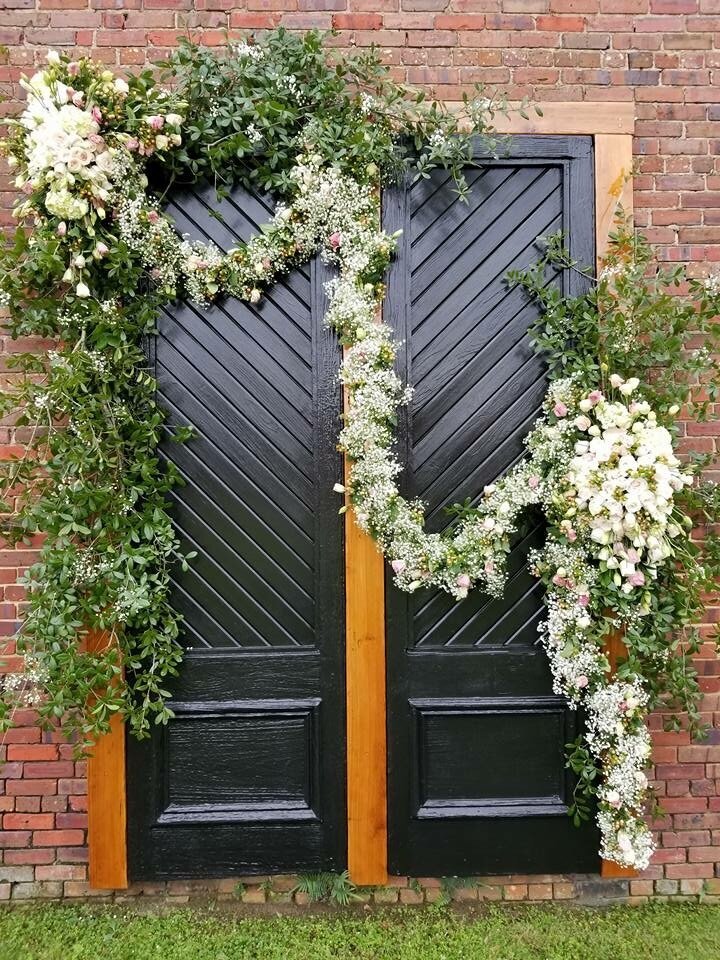 Venue on Palafox with Florals on Iconic Black Doors at Palafox Wharf Waterfront Venue Best wedding venue on Palafox