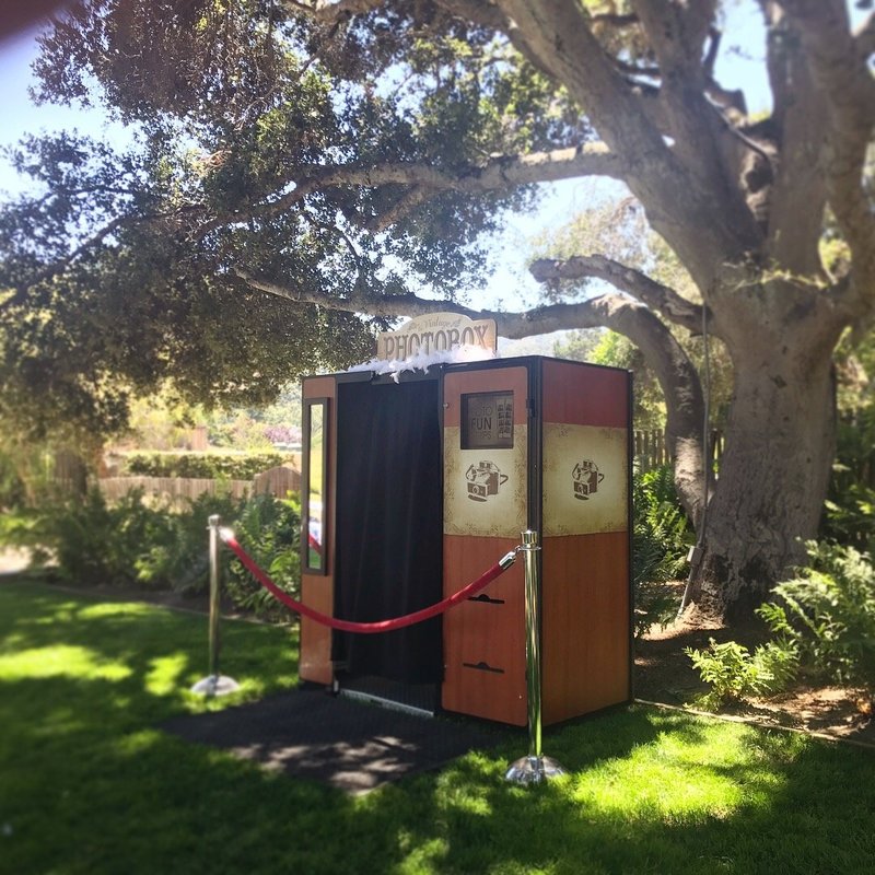 vintage photo booth next to a tree