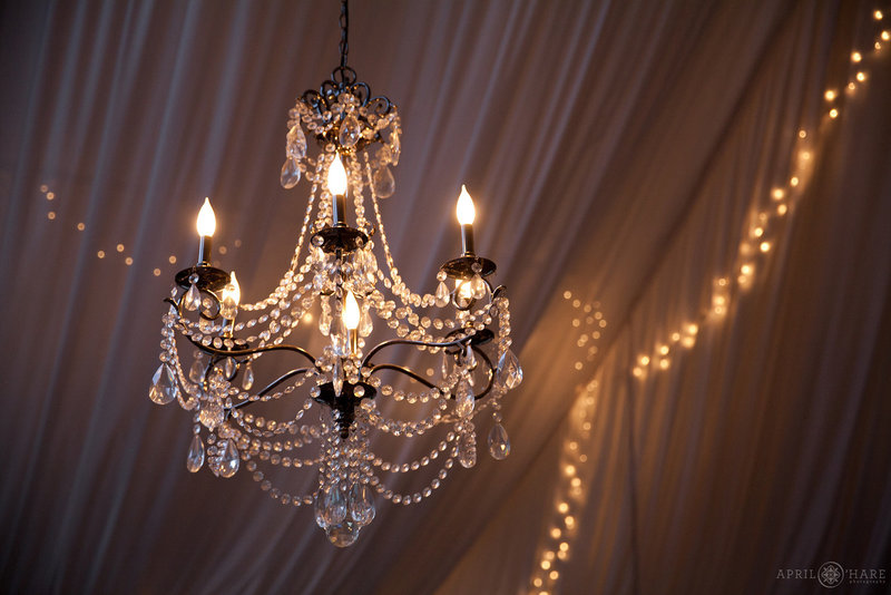 Beautiful Chandelier Hangs in Wedding Reception Tent at The Manor House in Littleton Colorado