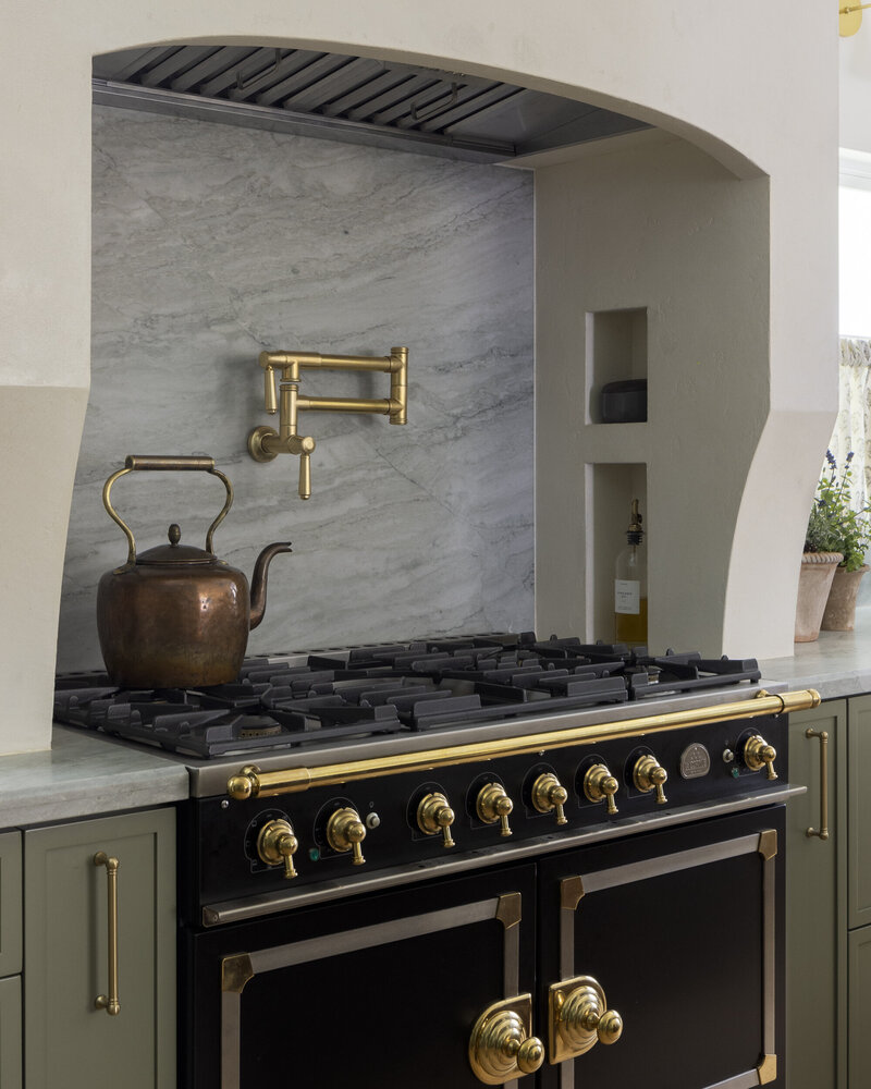 Kitchen remodel with green skinny shaker cabinets and wolf range with pot filler