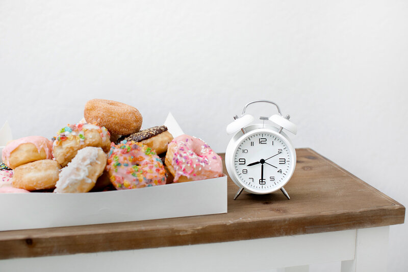 Colorful Fruity Pebble Donut on a White Background - Daylight Donuts