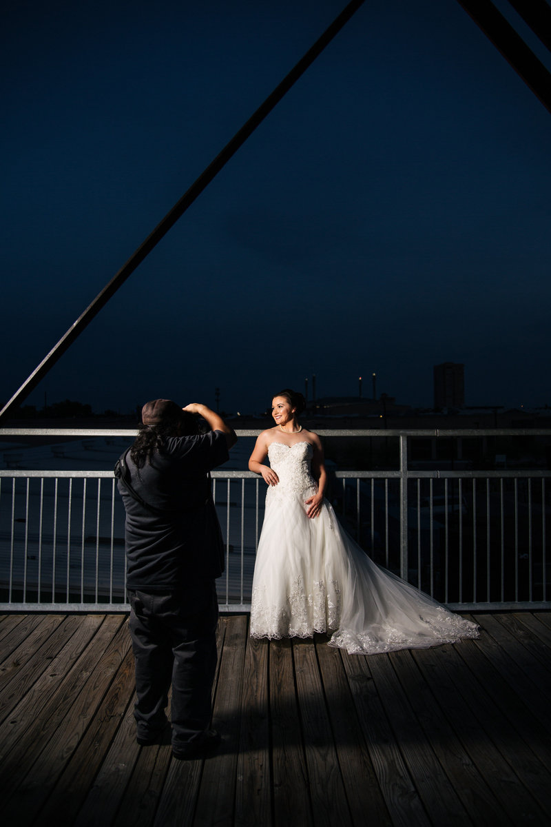 San Antonio Photographer David Castillo of Expose The Heart taking pictures of a bride at Hays Street Bridge