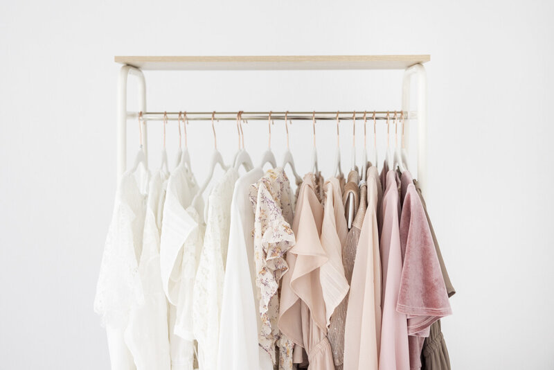rack of neutral and pink dresses for photoshoots