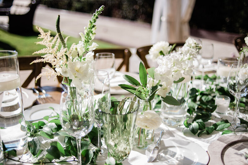Wedding reception table with white and green flowers