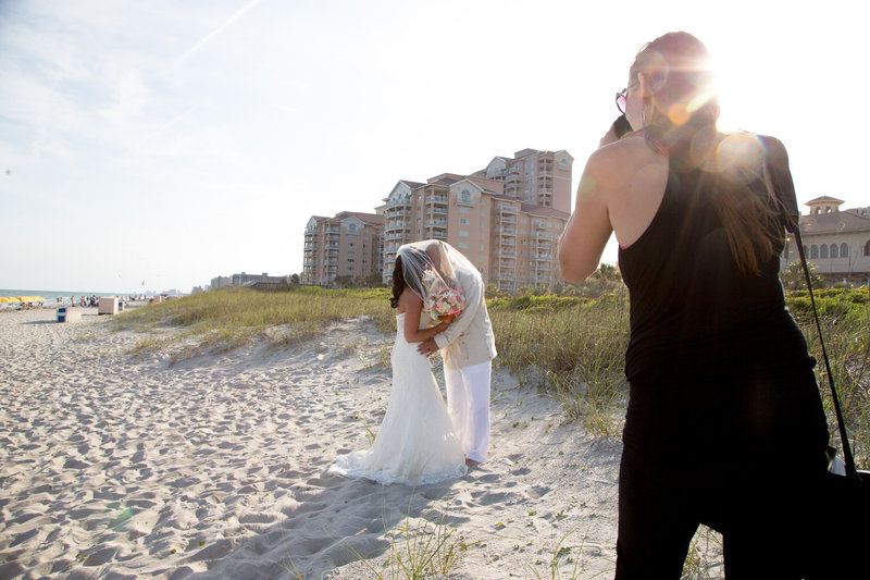 Myrtle Beach wedding photographer, Crystal Lee, photographs a bride and groom on the beach