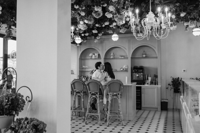 black and white engagement photos at restaurant