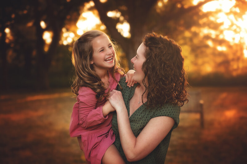tulsa fall family sessiom with beautiflu fall colors and mom and daughter smiling