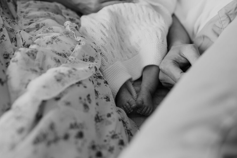 baby feet snuggling in bed