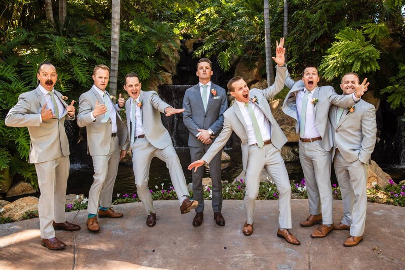 Groom and groomsmen in front of the waterfall at the Arbor Terrace wedding ceremony site at Grand Tradition Estate and Gardens in San Diego.
