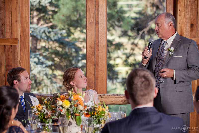 Wedding reception toasts inside the barn at Mountain View Ranch in Colorado