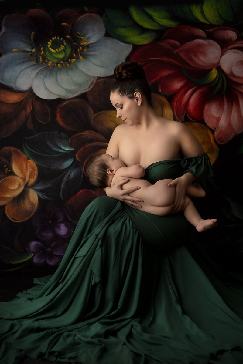 NJ Baby & Children Photographer Sarah Dubas sits in a studio  breastfeeding her infant child in her lap