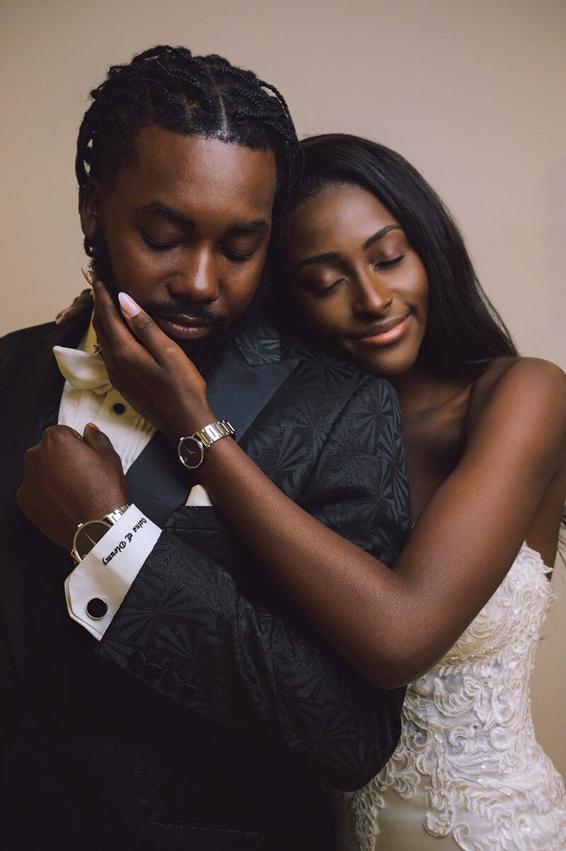 Black bride and groom with eyes closed
