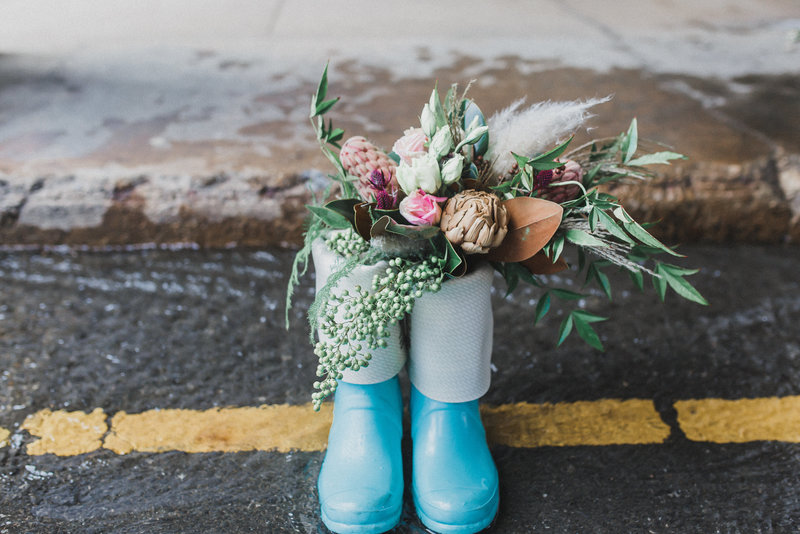 blue rain boots with bridal bouquet