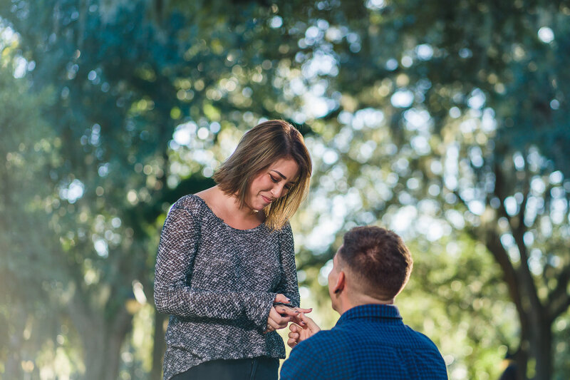 Boyfriend on one knee proposing at Forsyth Park in Savannah, GA. Engagement photography in Savannah, GA.