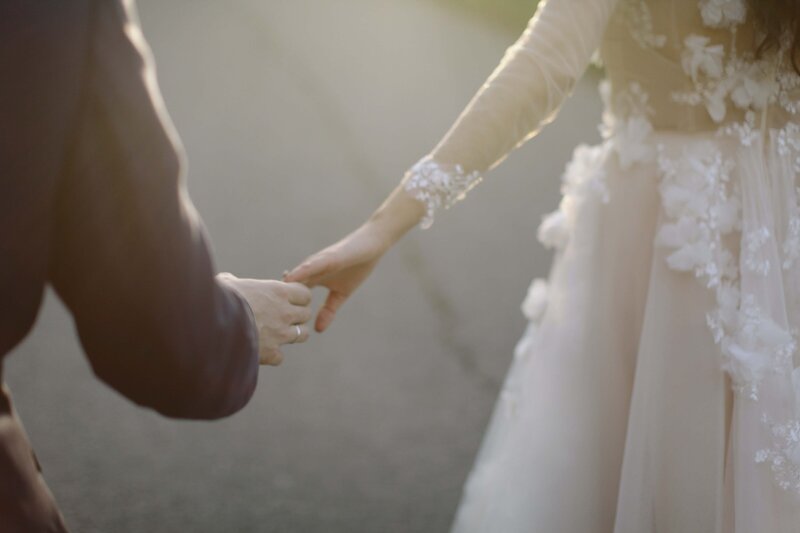 close up of hands of bride and groom