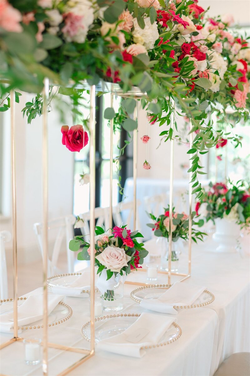 Step into a world of enchantment with our blush and hot pink floral bridge adorned with hanging blooms. Kendra’s Events crafts a captivating scene where nature and design converge in harmony, adding a touch of magic to your special day.
