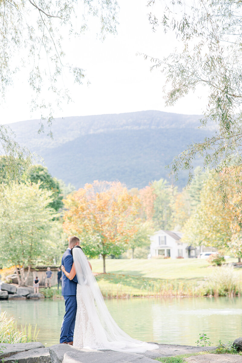 Bride and groom hugging and looking at the mountain representing the candid moments Christine Hazel Photography captures
