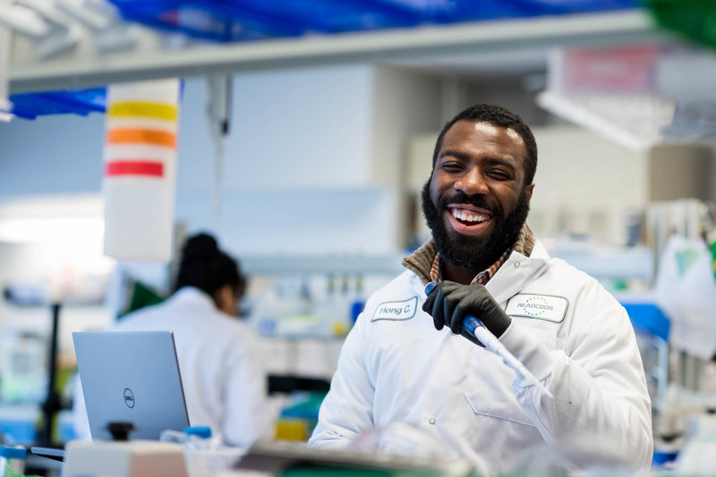 lab technician smiling in a lab